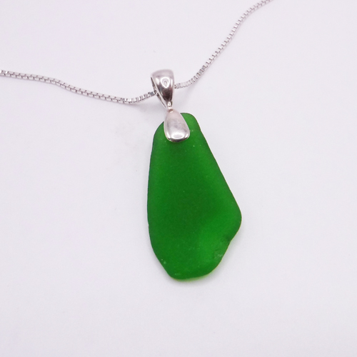 jade green sea glass pendant with a sterling silver bail on top